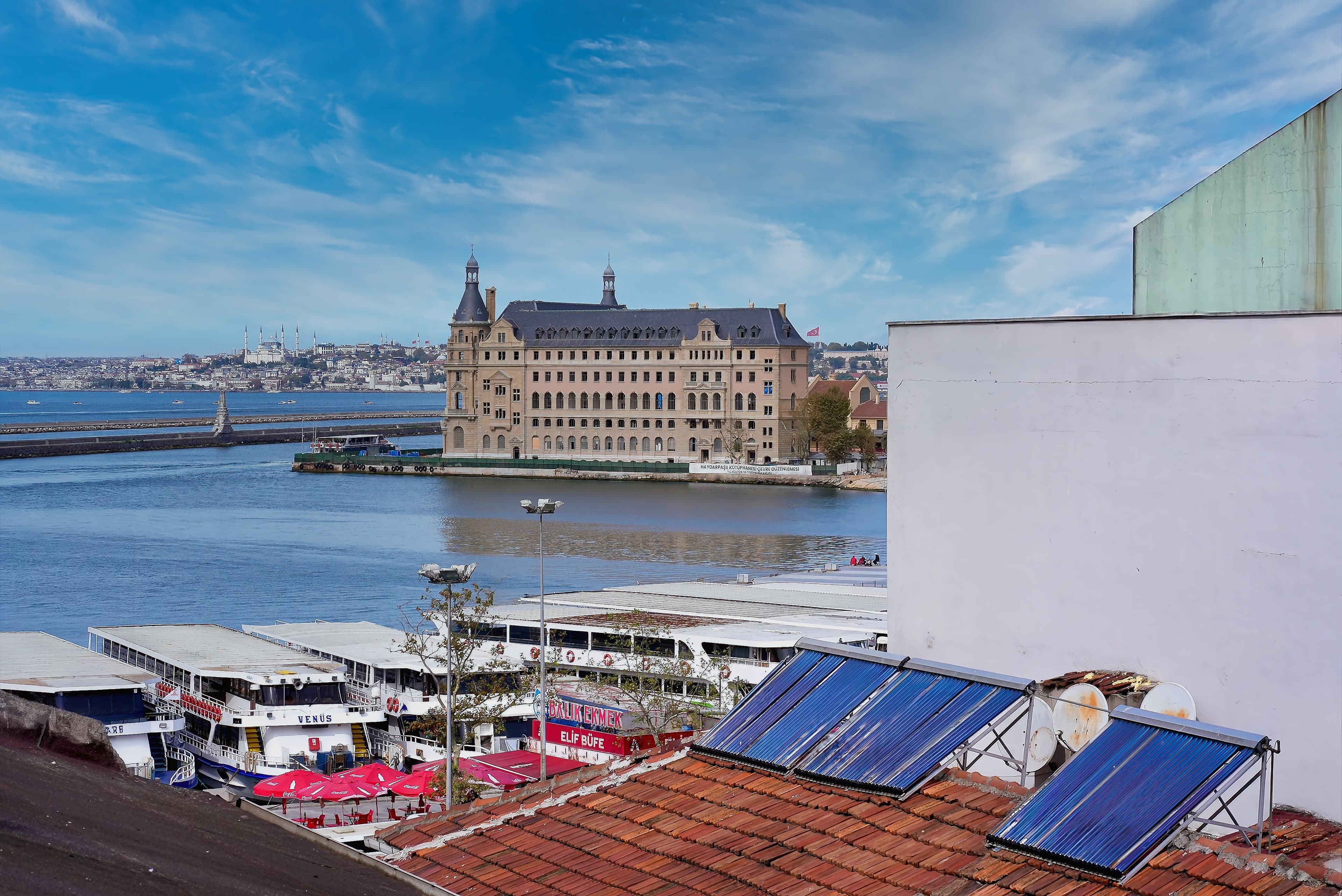 View from the rooftop terrace over the Kadıköy ferry piers to Haydarpaşa Station and the Bosphorus