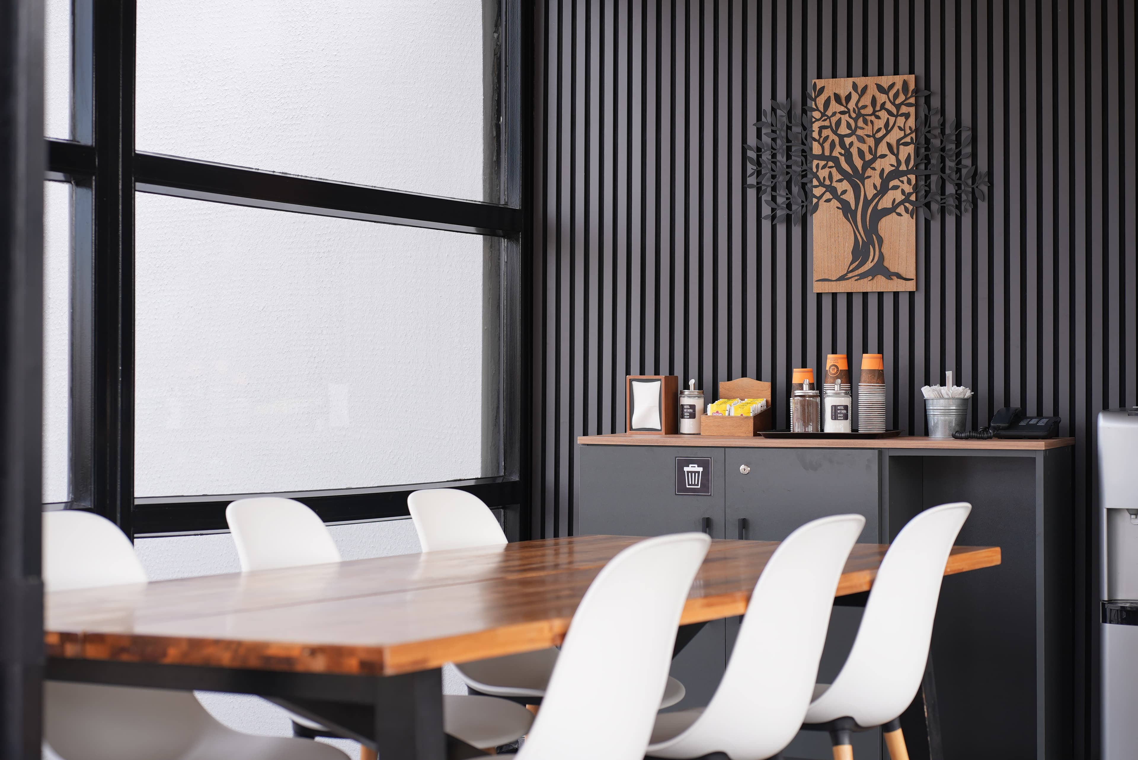 The 24/7 self-service tea and coffee corner in the rooftop sunroom, beside its long wooden table